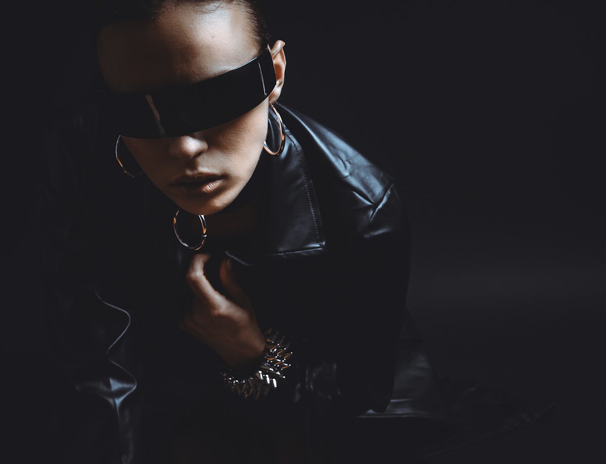 Woman in a black leather jacket and sunglasses